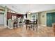 Inviting kitchen and dining area with dark wood cabinets, bar seating, and tile floors, perfect for entertaining at 5479 Saint Regis Way, Port Orange, FL 32128