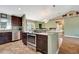 Open kitchen with stainless steel oven, granite countertops, and breakfast bar overlooking living area at 5479 Saint Regis Way, Port Orange, FL 32128