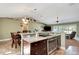 Open kitchen with stainless steel appliances, granite countertops, and eat in dining area at 5479 Saint Regis Way, Port Orange, FL 32128