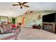 Cozy living room featuring an entertainment center, vaulted ceiling, and view of the dining room at 5479 Saint Regis Way, Port Orange, FL 32128