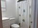 A cozy bathroom featuring a toilet and a playful, fish-themed shower curtain at 5500 Ocean Shore Blvd # Ut18, Ormond Beach, FL 32176