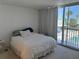 Bedroom with sliding glass doors to patio; view of swimming pool at 5500 Ocean Shore Blvd # Ut18, Ormond Beach, FL 32176