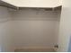 Empty walk in closet with rod for hanging clothes and neutral carpeting at 5500 Ocean Shore Blvd # Ut18, Ormond Beach, FL 32176