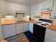 Well-equipped kitchen featuring white cabinetry, wood countertops, and practical appliances for everyday cooking at 5500 Ocean Shore Blvd # Ut18, Ormond Beach, FL 32176