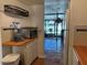 Galley kitchen with updated cabinets and countertops, offering ample storage and workspace with access to a bright sunroom at 5500 Ocean Shore Blvd # Ut18, Ormond Beach, FL 32176