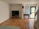 Bright living room with tile floors, a large television, and ample natural light, creating a welcoming space at 5500 Ocean Shore Blvd # Ut18, Ormond Beach, FL 32176