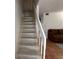 Carpeted staircase leading to upper level, providing access to private living spaces with a light and airy feel at 5500 Ocean Shore Blvd # Ut18, Ormond Beach, FL 32176