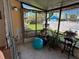 Enclosed lanai with sliding door offering space for relaxation, plants, and views of the surrounding landscaped grounds at 5500 Ocean Shore Blvd # Ut18, Ormond Beach, FL 32176