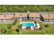Aerial view of condos with community pool, well-manicured landscaping, and exterior buildings at 563 Belltower Ave # 240, Deltona, FL 32725
