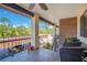 Cozy balcony space with outdoor seating, iron railing, and a calming view of trees and parked car at 563 Belltower Ave # 240, Deltona, FL 32725