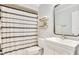 Clean bathroom featuring vanity storage and a modern decorative shower curtain at 563 Belltower Ave # 240, Deltona, FL 32725