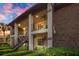 Charming two-story apartment building featuring lush landscaping, stairs, and well-lit balconies at 563 Belltower Ave # 240, Deltona, FL 32725