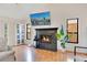 Bright living room featuring a fireplace, large windows and a comfortable seating arrangement at 563 Belltower Ave # 240, Deltona, FL 32725