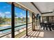 Enclosed patio overlooking the pool with a dining table, tv, and outdoor lounge area at 563 Belltower Ave # 240, Deltona, FL 32725