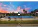 Inviting community pool surrounded by palm trees and lush landscaping, perfect for relaxation and recreation at 563 Belltower Ave # 240, Deltona, FL 32725