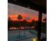 Beautiful sunset view overlooking the pool and reflecting on the water at dusk at 563 Belltower Ave # 240, Deltona, FL 32725