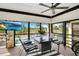 Relaxing enclosed porch offering views of the lake, pool, and sunny Florida landscape at 563 Belltower Ave # 240, Deltona, FL 32725