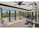 Enclosed sunroom featuring an exercise area, view of the pool and lake, and a mounted television at 563 Belltower Ave # 240, Deltona, FL 32725