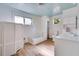 Bright bathroom with blue ceiling, a tub, vanity, and natural lighting at 607 Herbert St, Port Orange, FL 32129
