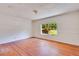Spacious bedroom with hardwood floors and a large window overlooking the yard at 607 Herbert St, Port Orange, FL 32129