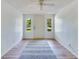 Bright entryway features hardwood floors, white walls, and natural lighting at 607 Herbert St, Port Orange, FL 32129