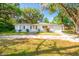 Charming single-story home with mature trees, shutters, and a front yard at 607 Herbert St, Port Orange, FL 32129