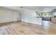 Open-concept living room with hardwood floors connecting to the kitchen at 607 Herbert St, Port Orange, FL 32129