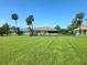 Large grassy backyard, perfect for outdoor activities, with a screened porch at 6182 Knotty Pine Ct, Port Orange, FL 32127