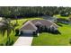 Aerial view of a single-Gathering home with mature landscaping and a two-car garage at 6182 Knotty Pine Ct, Port Orange, FL 32127
