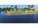 Charming single-story home with a sprawling lawn and serene water views from the backyard at 6182 Knotty Pine Ct, Port Orange, FL 32127