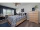 Bedroom featuring blue and white patterned bedding, bay window and a chest of drawers at 6194 Half Moon Dr, Port Orange, FL 32127