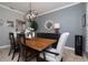 Stylish dining room showcasing a rustic wood table and modern black chandelier at 6194 Half Moon Dr, Port Orange, FL 32127