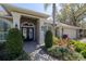 Elegant home entrance with stately columns, double doors, and meticulously maintained landscaping at 6194 Half Moon Dr, Port Orange, FL 32127