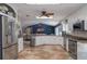 Spacious kitchen offering granite countertops, white cabinetry, stainless appliances, and an eat-in breakfast bar at 6194 Half Moon Dr, Port Orange, FL 32127