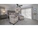 Tranquil main bedroom featuring a ceiling fan, plush carpet, and bright, airy natural light at 6194 Half Moon Dr, Port Orange, FL 32127