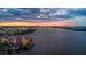 Scenic sunset aerial view showcasing the waterfront condo complex, bridge, and city at 761 Marina Point Dr # 7610, Daytona Beach, FL 32114