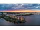 Picturesque sunset aerial view showcasing the waterfront condo complex, and city at 761 Marina Point Dr # 7610, Daytona Beach, FL 32114