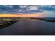 Majestic sunset aerial view showcasing the bridge, and cityscape reflecting on the tranquil water at 761 Marina Point Dr # 7610, Daytona Beach, FL 32114
