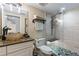 The remodeled bathroom offers a frameless shower with stone tile and a vessel sink at 761 Marina Point Dr # 7610, Daytona Beach, FL 32114