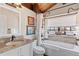 Bright bathroom featuring a vanity, a shower, and a large window at 761 Marina Point Dr # 7610, Daytona Beach, FL 32114