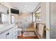 Bright bathroom featuring a marble vanity, frameless shower, and views of outdoor scenery at 761 Marina Point Dr # 7610, Daytona Beach, FL 32114