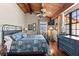 Cozy bedroom with a floral-patterned bedspread, a blue dresser, and a ceiling fan at 761 Marina Point Dr # 7610, Daytona Beach, FL 32114