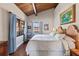 This bedroom features vaulted ceilings, wood beams and tropical decor at 761 Marina Point Dr # 7610, Daytona Beach, FL 32114