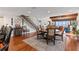 Open concept dining room shows hardwood floors, staircase, and contemporary furnishings at 761 Marina Point Dr # 7610, Daytona Beach, FL 32114