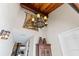 Elegant foyer showcasing a decorative chandelier, unique wall sconce, and rustic cabinet at 761 Marina Point Dr # 7610, Daytona Beach, FL 32114