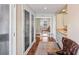 Hallway with hardwood floors, closet storage, bathroom vanity, and full length mirror at 761 Marina Point Dr # 7610, Daytona Beach, FL 32114