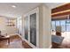 Hallway features hardwood floors, glass paneled closet doors, and serene water view at 761 Marina Point Dr # 7610, Daytona Beach, FL 32114