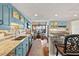 Well-appointed kitchen features blue cabinets, stainless appliances, granite counters, and scenic water views at 761 Marina Point Dr # 7610, Daytona Beach, FL 32114
