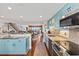 Modern kitchen open to the living area with waterfront views and a staircase at 761 Marina Point Dr # 7610, Daytona Beach, FL 32114