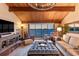 Spacious living room with wood-beamed ceiling, chandelier, and expansive water view at 761 Marina Point Dr # 7610, Daytona Beach, FL 32114